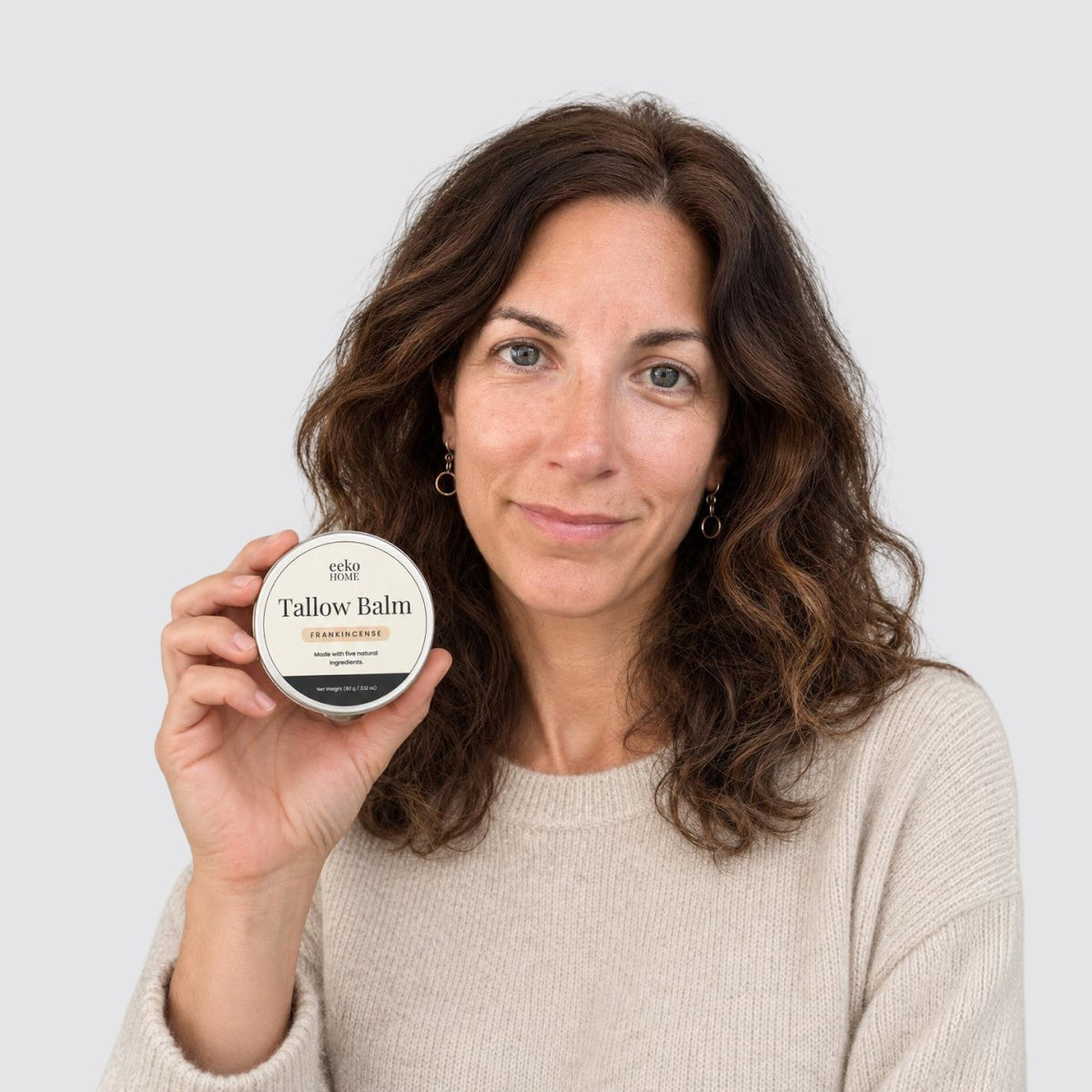 Woman holding the eekoHome Tallow Balm tin
